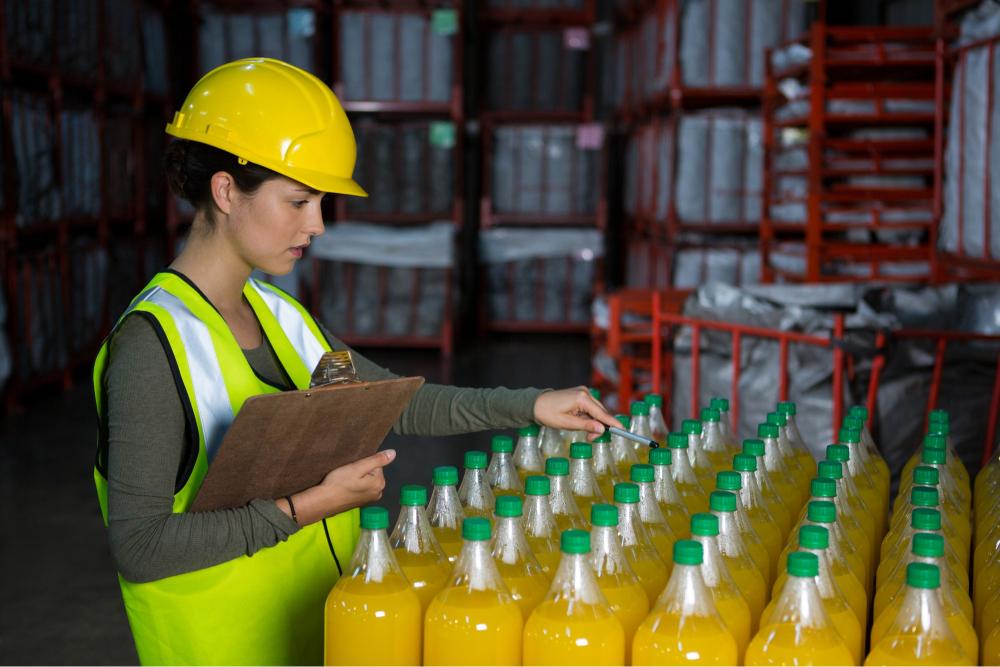 female-worker-examining-juice-bottles (1)